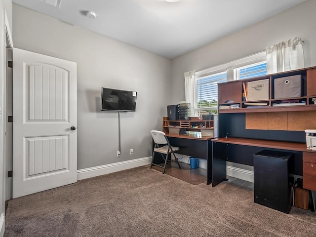 home office featuring baseboards and dark colored carpet