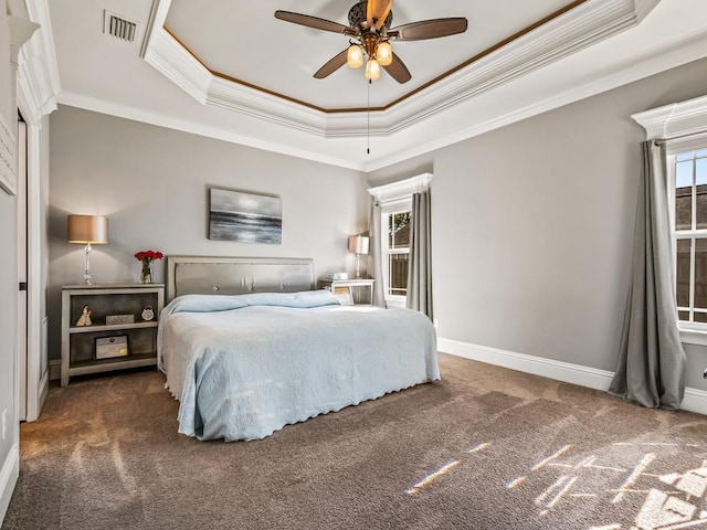 bedroom featuring a raised ceiling, visible vents, dark carpet, and baseboards