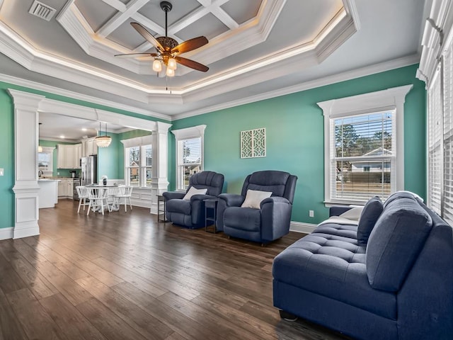 living room featuring a healthy amount of sunlight, ornate columns, visible vents, and dark wood-type flooring