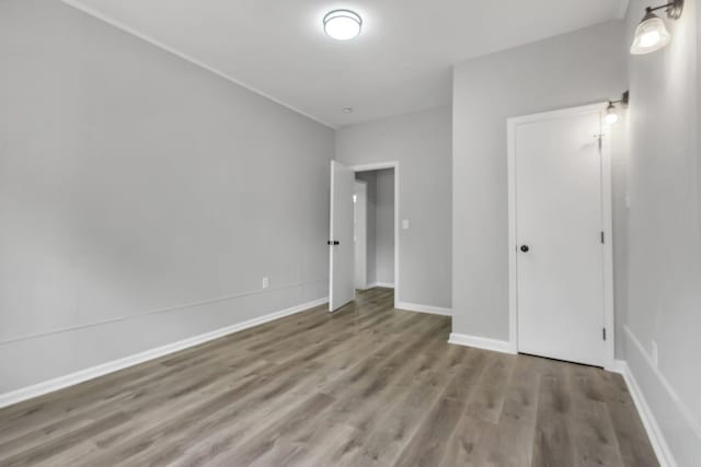 2212 Berkshire Dr, Tallahassee, FL 32304 - unfurnished bedroom with baseboards and wood finished floors
