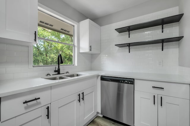2212 Berkshire Dr, Tallahassee, FL 32304 - kitchen with light countertops, dishwasher, a sink, and backsplash