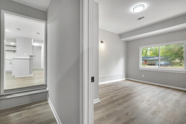 2212 Berkshire Dr, Tallahassee, FL 32304 - hall featuring wood finished floors, baseboards, and visible vents