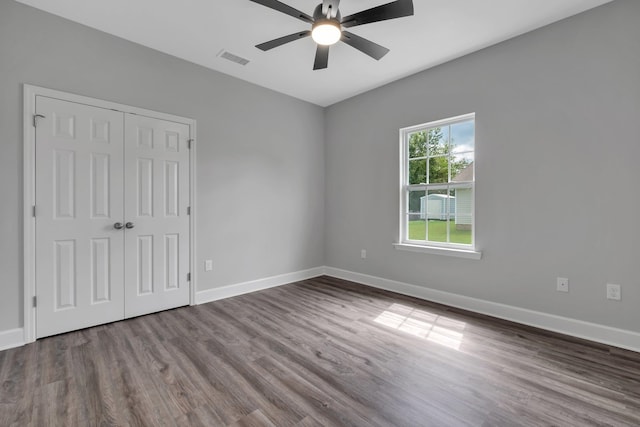 empty room with hardwood / wood-style flooring and ceiling fan