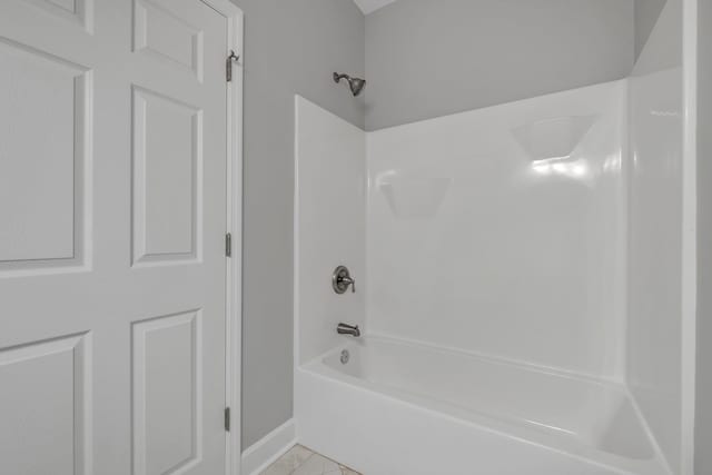 bathroom with tile patterned flooring and shower / bathing tub combination