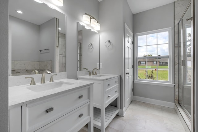 bathroom featuring plenty of natural light, walk in shower, and vanity