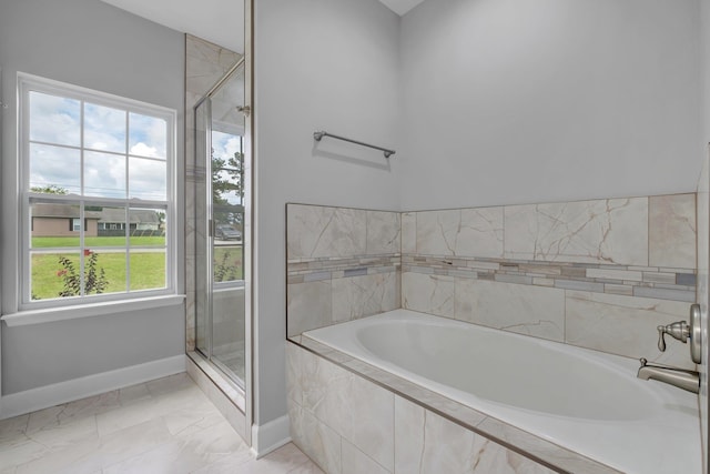 bathroom with separate shower and tub and a wealth of natural light