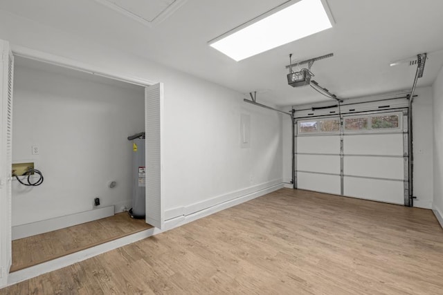 3142 Seattle Slew Ct, Tallahassee, FL 32309 - garage with electric water heater, a garage door opener, and baseboards