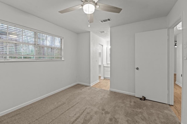3142 Seattle Slew Ct, Tallahassee, FL 32309 - unfurnished bedroom with light colored carpet, baseboards, ensuite bath, and a ceiling fan