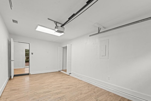 3142 Seattle Slew Ct, Tallahassee, FL 32309 - garage featuring a garage door opener, baseboards, and electric panel