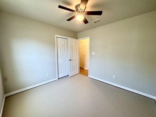 27 Pirates Cove Ln, Saint Marks, FL 32355 - unfurnished bedroom with a closet, a ceiling fan, and concrete flooring