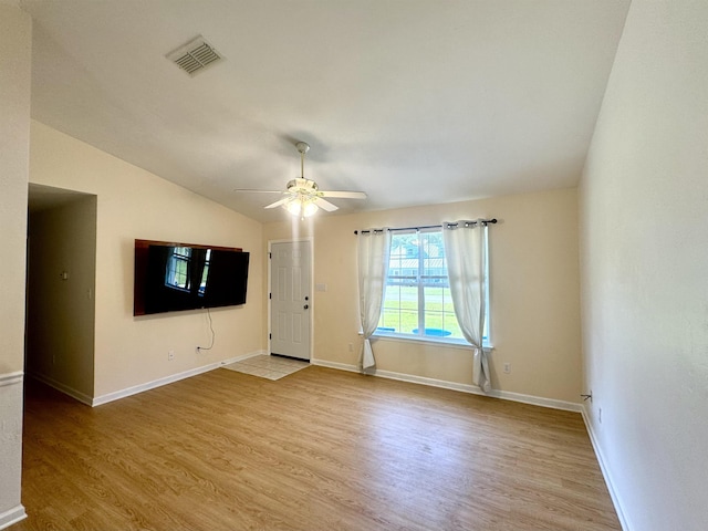 27 Pirates Cove Ln, Saint Marks, FL 32355 - unfurnished living room with wood finished floors, ceiling fan, and vaulted ceiling