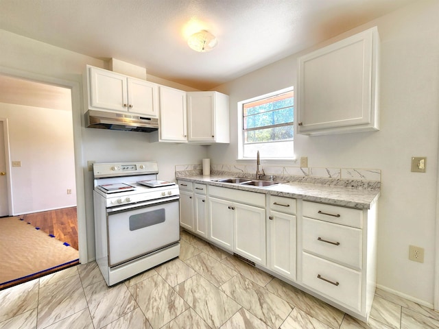 kitchen with white stove, sink, and white cabinets