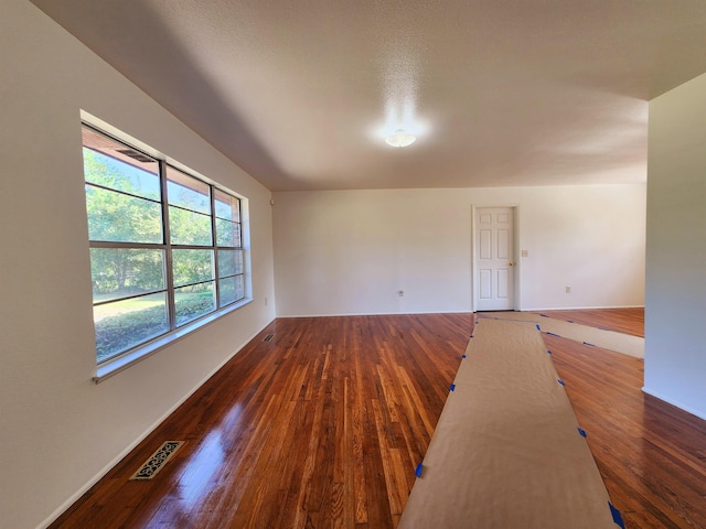 empty room featuring dark wood-type flooring