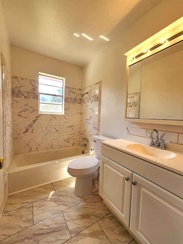 full bathroom featuring vanity, tiled shower / bath, toilet, and decorative backsplash