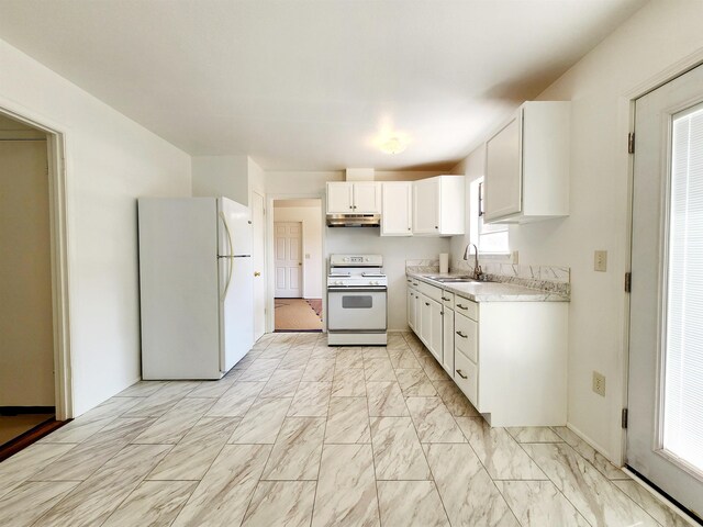 kitchen featuring white cabinetry, sink, and white appliances