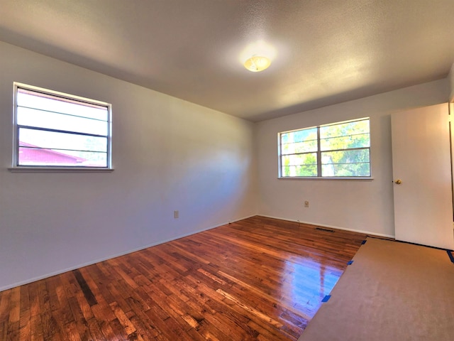 spare room with dark hardwood / wood-style flooring