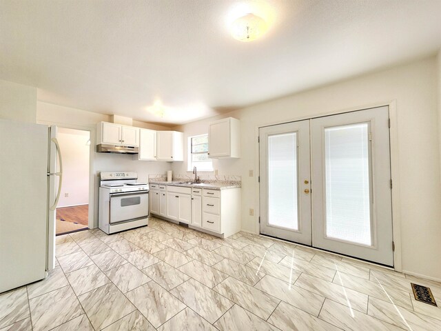 kitchen with white cabinetry, french doors, sink, and white appliances