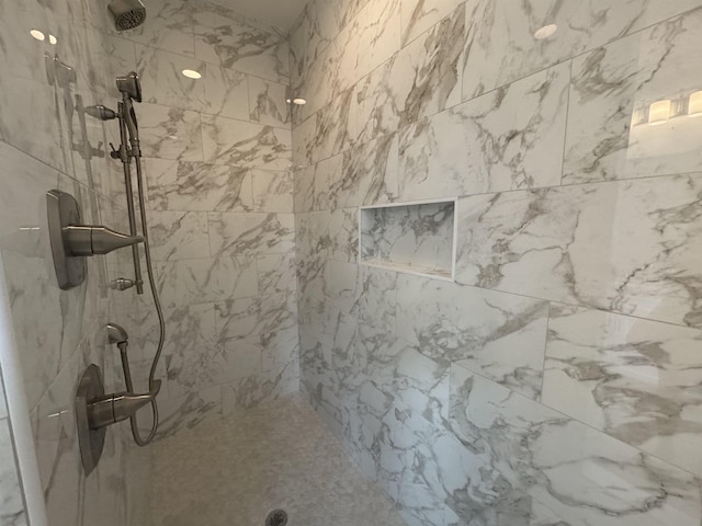 bathroom with a tile shower