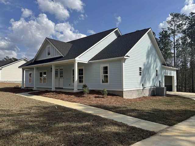 view of front of property with roof with shingles, a porch, an attached garage, central AC unit, and board and batten siding