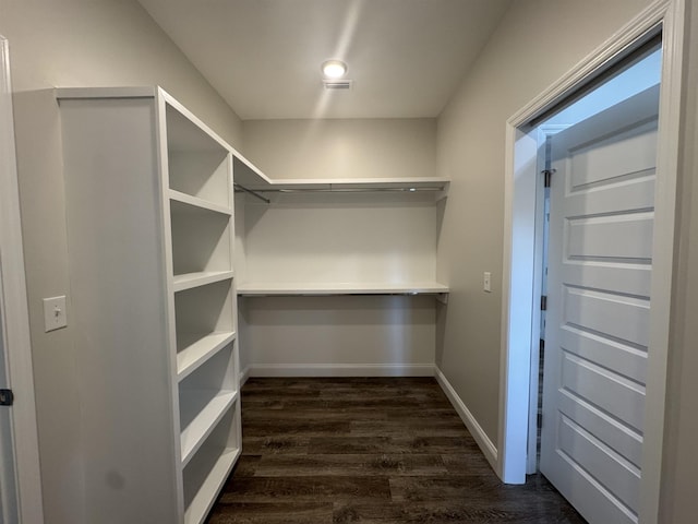 walk in closet featuring visible vents and dark wood finished floors