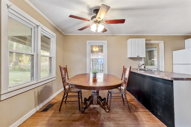 450 W Dogwood St, Monticello, FL 32344 - dining space with baseboards, visible vents, a ceiling fan, ornamental molding, and wood finished floors
