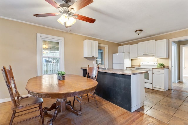 450 W Dogwood St, Monticello, FL 32344 - kitchen featuring white appliances, under cabinet range hood, and white cabinetry