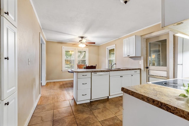 450 W Dogwood St, Monticello, FL 32344 - kitchen featuring crown molding, dark countertops, white cabinets, a sink, and dishwasher