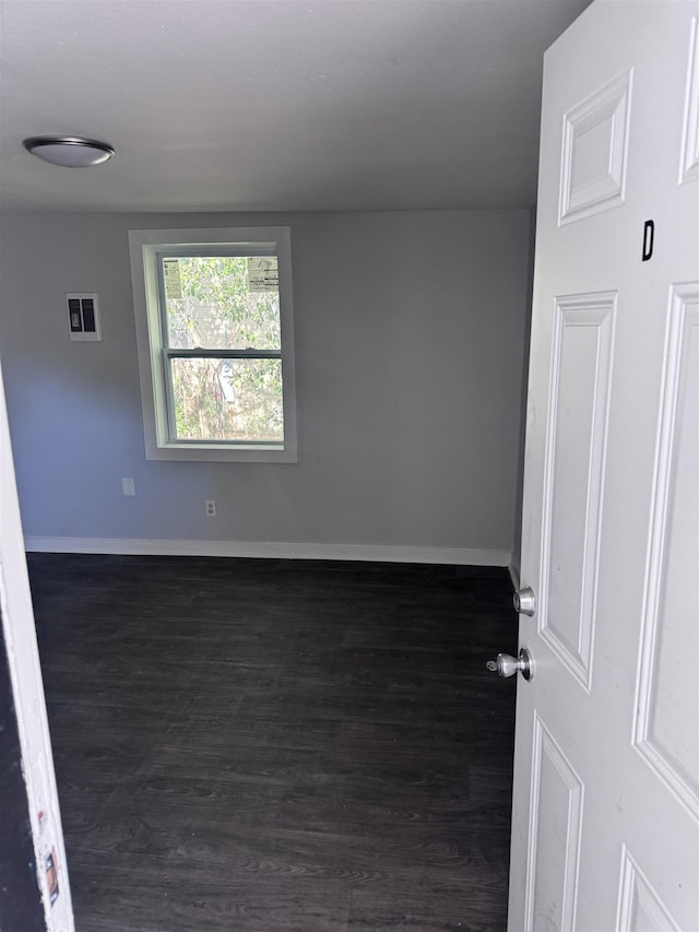 empty room featuring dark wood-type flooring