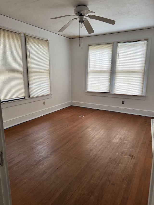 empty room featuring dark hardwood / wood-style floors and ceiling fan