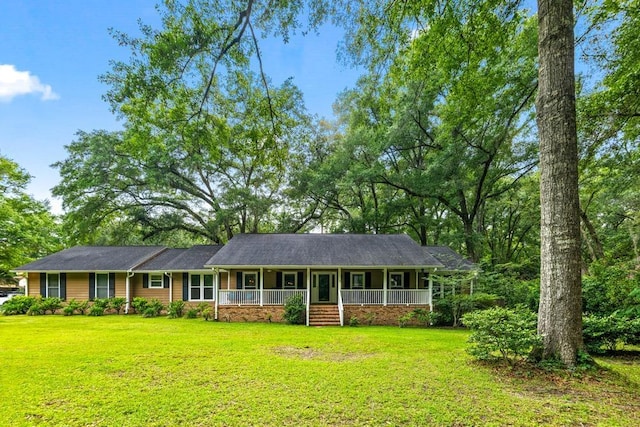 ranch-style house with a front yard and covered porch