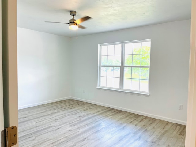 spare room featuring ceiling fan and light hardwood / wood-style flooring