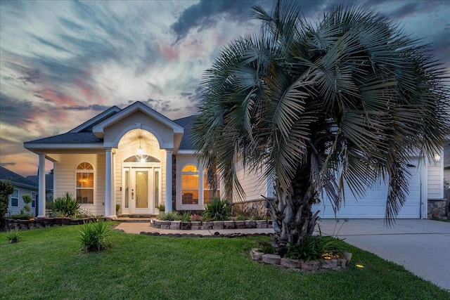 view of front of home with a lawn and a garage