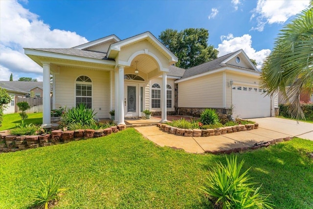 view of front of property featuring a garage and a front yard