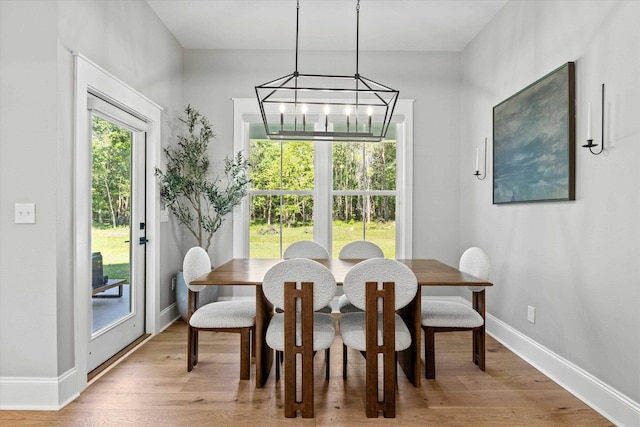 1020 Baum Rd, Tallahassee, FL 32317 - dining area featuring a chandelier, baseboards, and light wood-style floors