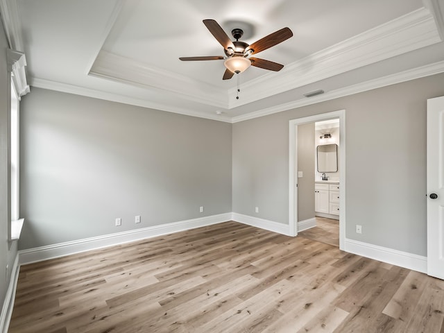 57 Mohawk Trl, Crawfordville, FL 32327 - unfurnished bedroom with light wood-style flooring, a raised ceiling, visible vents, and crown molding