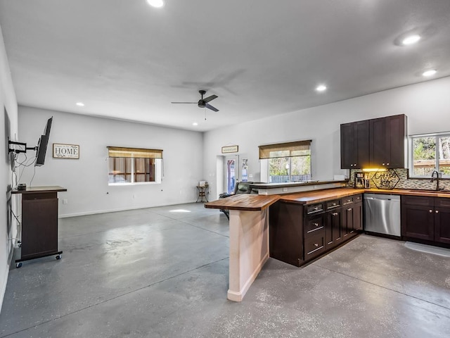 kitchen with kitchen peninsula, a healthy amount of sunlight, sink, and stainless steel dishwasher