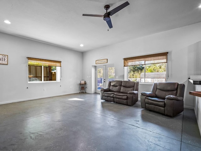 living room featuring ceiling fan and french doors