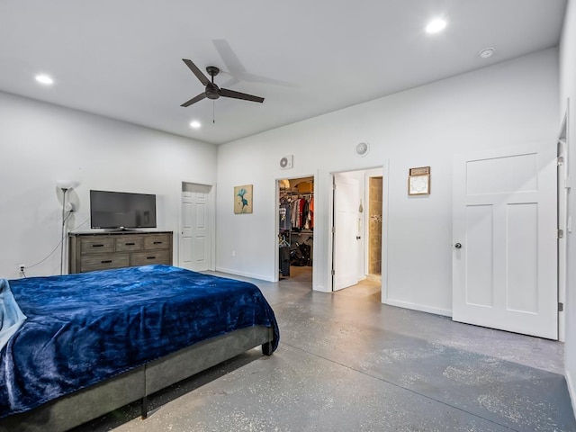 bedroom featuring a walk in closet, ceiling fan, and a closet