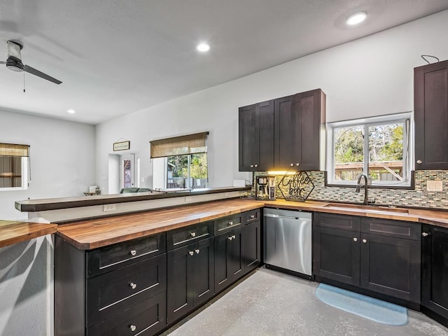 kitchen featuring kitchen peninsula, stainless steel dishwasher, ceiling fan, sink, and butcher block countertops