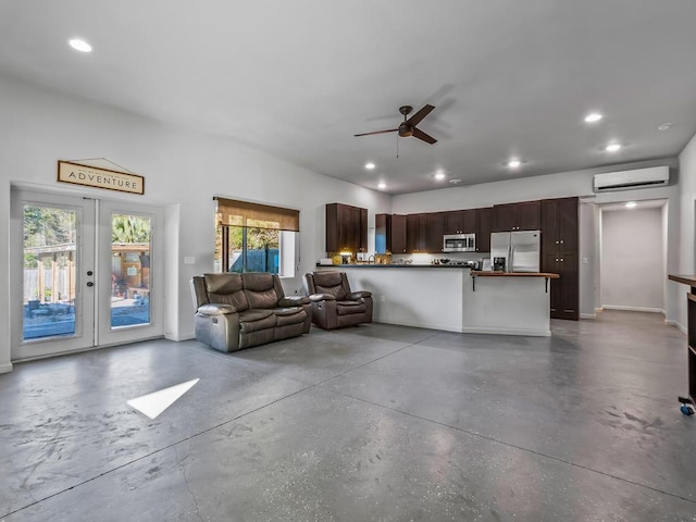 unfurnished living room with a wall mounted air conditioner, ceiling fan, french doors, and concrete floors