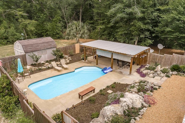 view of swimming pool with a bar, a patio area, and an outdoor structure