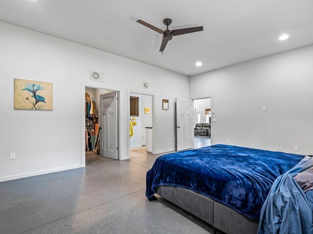 bedroom with a walk in closet, ceiling fan, and a closet