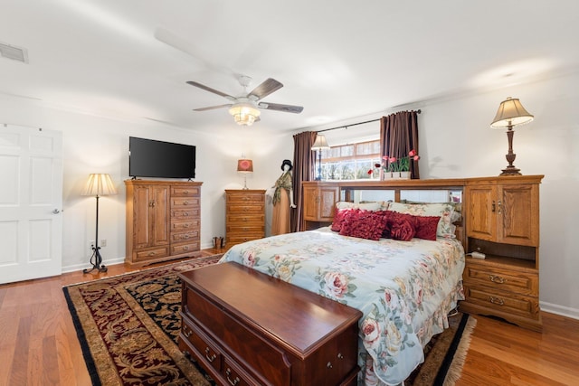 bedroom with ceiling fan and light wood-type flooring