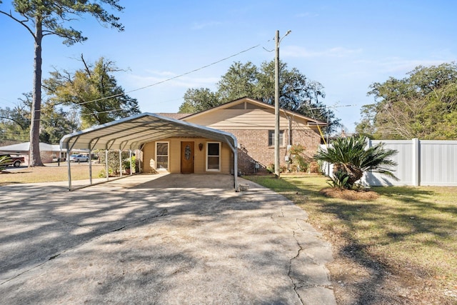 view of front of property featuring a carport and a front lawn