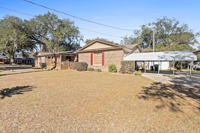 ranch-style house featuring a porch, a carport, and a front lawn