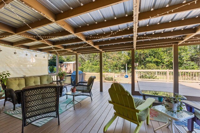 wooden deck featuring a shed and outdoor lounge area