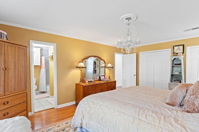 bedroom with ornamental molding, connected bathroom, a chandelier, and light hardwood / wood-style flooring