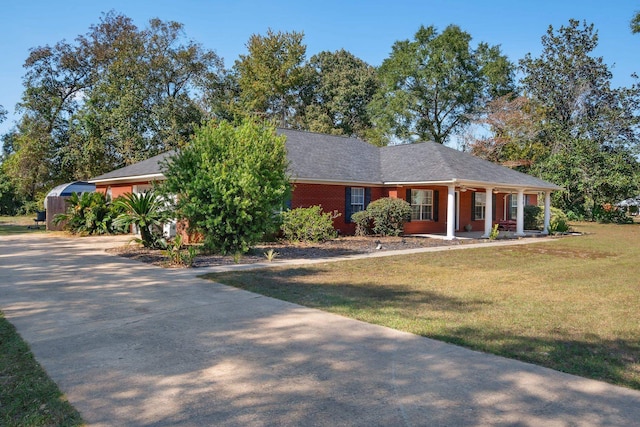 ranch-style home with covered porch and a front lawn