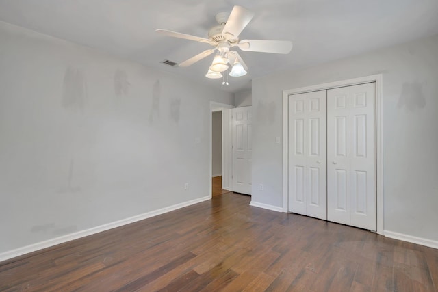 unfurnished bedroom featuring a closet, ceiling fan, and dark hardwood / wood-style floors