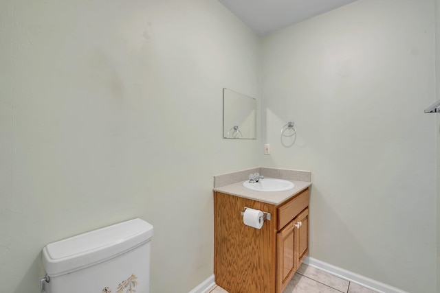 bathroom with vanity, toilet, and tile patterned floors